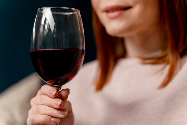 Portrait woman at home relaxing with glass of wine