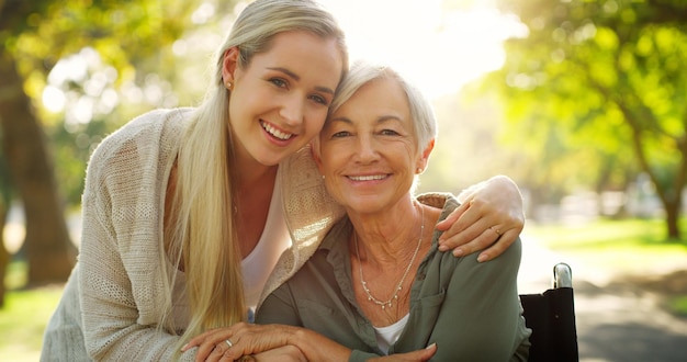 Portrait woman and mom in wheelchair for mothers day happiness and support in nature for love Smile hug and family in park for exercise senior person and retirement in summer for adventure