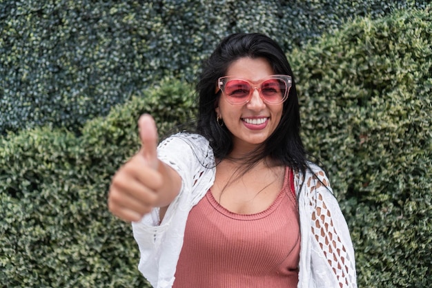 Portrait of woman in pink sunglasses in outdoor