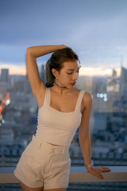 Portrait woman posing on balcony with city view