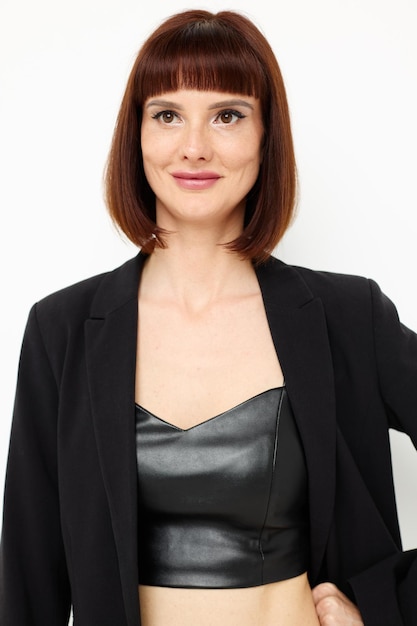 Portrait of a woman in a shorthaired leather suit light background