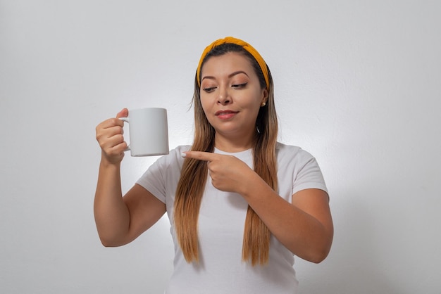 Portrait of woman showing a white cup Person holding a cup of coffee white background