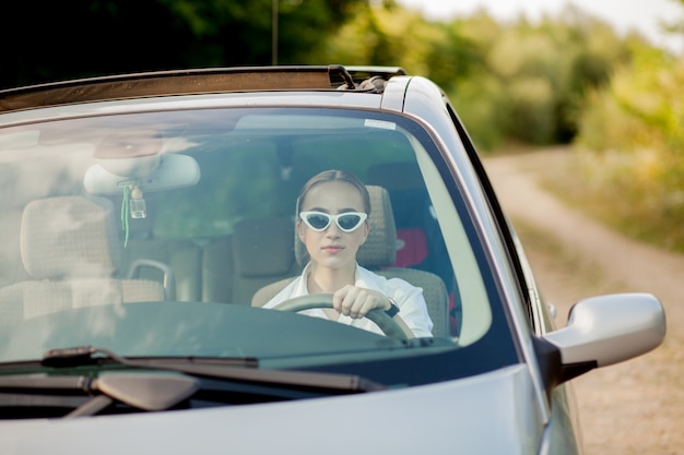 Portrait of a woman sitting in a car