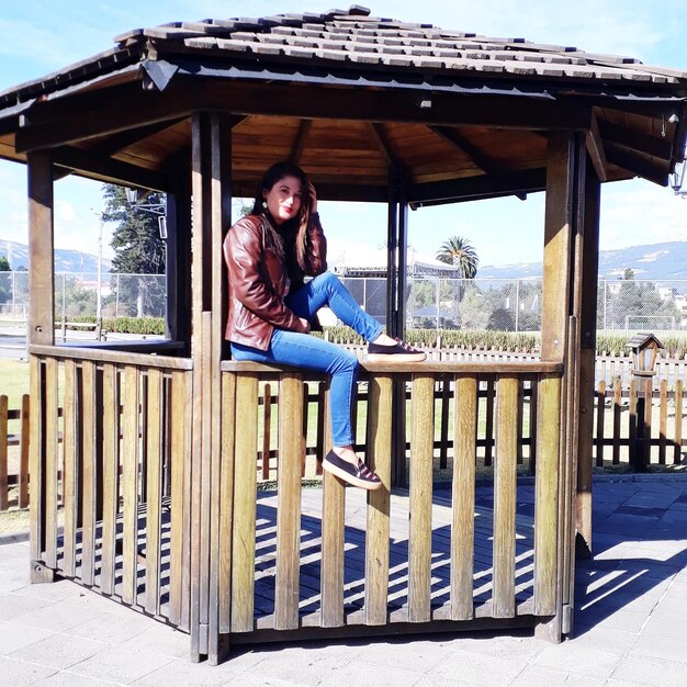 Portrait of woman sitting at gazebo