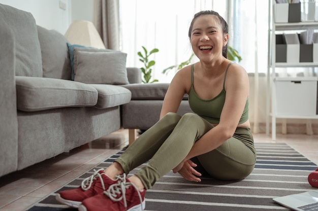 Portrait of woman sitting for resting exercise Exercise indoors during quarantine Exercise