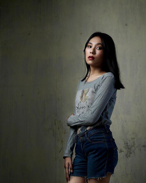 Portrait of woman standing against wall