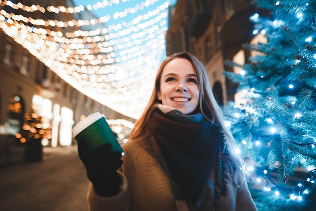 portrait woman on street with cup of coffee