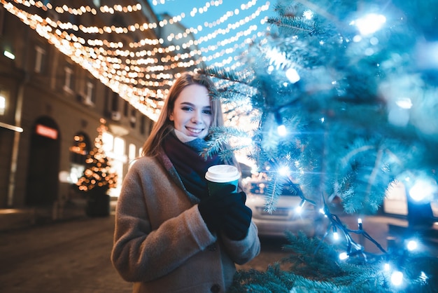 portrait woman on street with cup of coffee