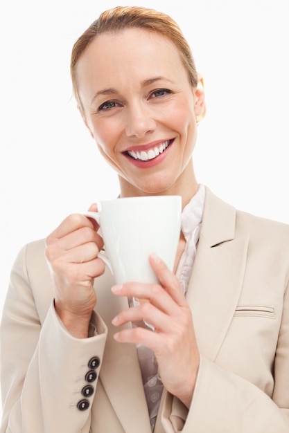 Portrait of a woman in a suit holding a mug