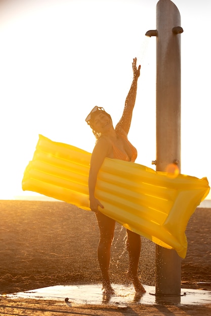 Portrait of woman taking a shower on the beach