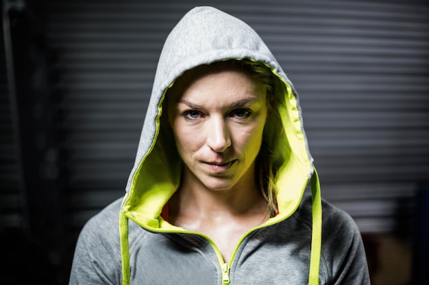 Portrait of woman wearing hood at gym