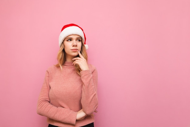 portrait woman wearing Santa hat with phone