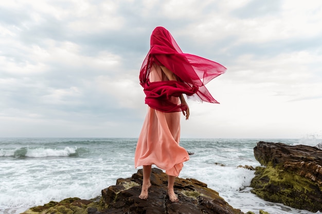 Portrait of woman with face covered by veil at the beach