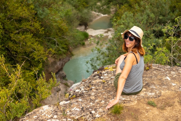 Portrait of a woman with a hat enjoying the peace of nature in the Pyrenees Panticosa