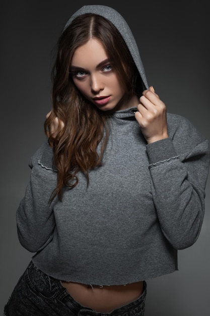 Portrait of woman with long hair in gray sweater