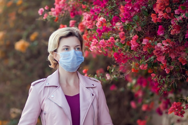 A portrait of woman with medical face mask outdoor. People, healthcare and medicine concept