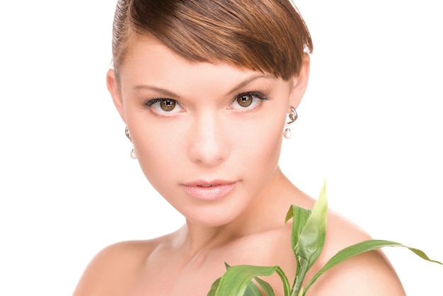 portrait of woman with sprout over white wall