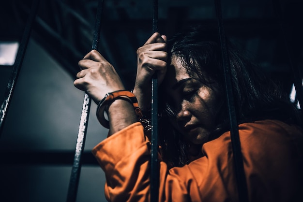 Portrait of women desperate to catch the iron prisonprisoner conceptthailand peopleHope to be freeIf the violate the law would be arrested and jailed