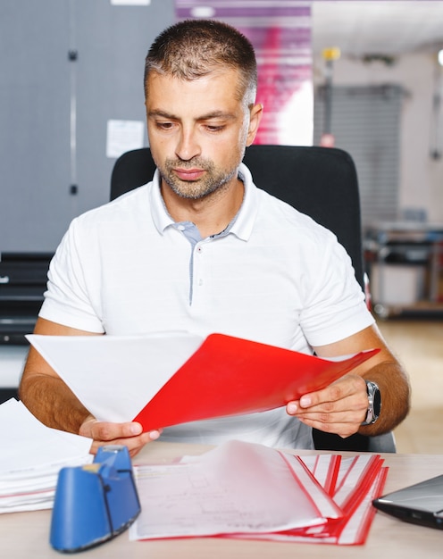 Portrait of a working man at a printer studio