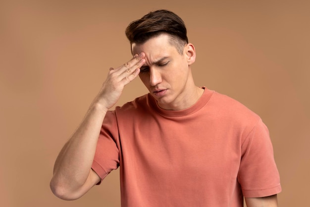 Portrait of worried anxious man touching head feeling pain suffering migraine problems