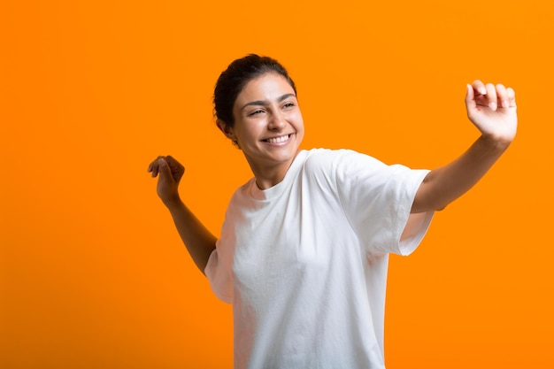 Portrait of young adult indian dancing woman in Tshirt