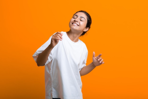 Portrait of young adult indian dancing woman in Tshirt