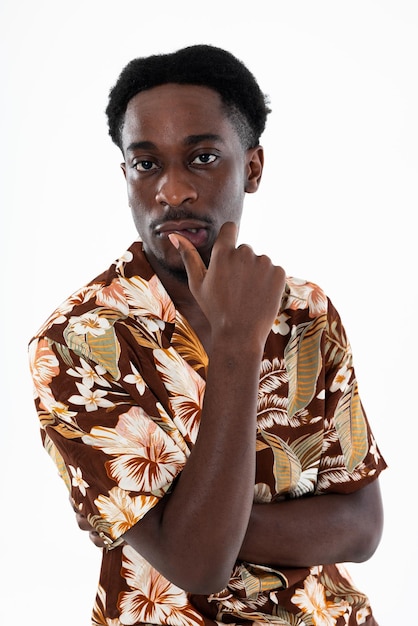 Portrait of young affricanamerican man thinking looking at camera holding arm near face