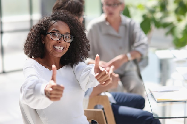 Portrait of a young african american woman in the office at the table