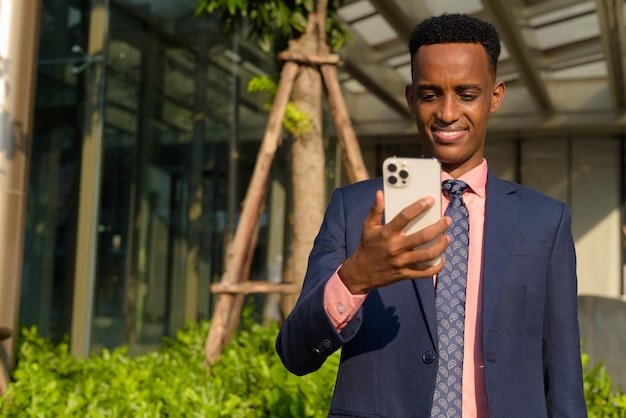 Portrait of young African businessman wearing suit and tie