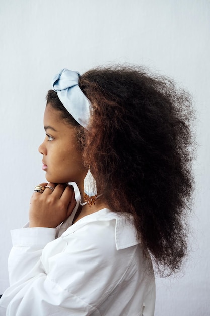 Portrait of young african woman with headscarf and ethnic jewelry african beautiful brunette curly