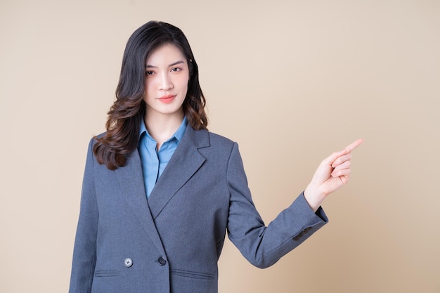 Portrait of young Asian business woman on background