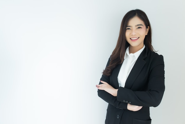 Portrait of young asian business woman crossed her arms over white background.