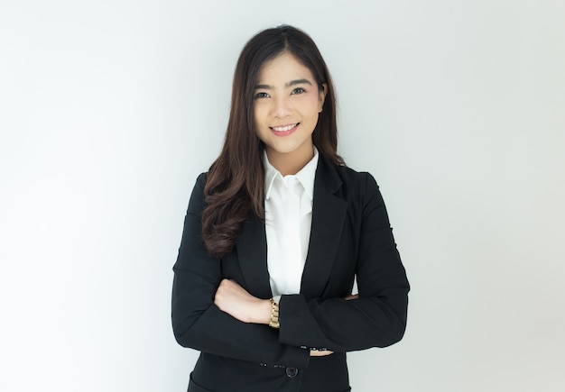 Portrait of young asian business woman crossed her arms over white background.