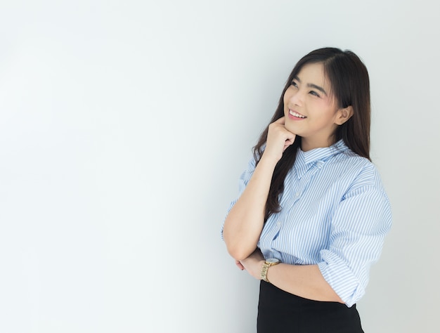 Portrait of young asian business woman thinking over white background.