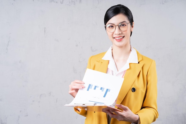 Portrait of young Asian businesswoman on background