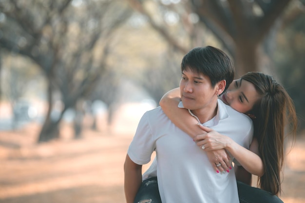 Portrait of young asian couple in love in the forestThailand people happy to be togetherValentine day concept