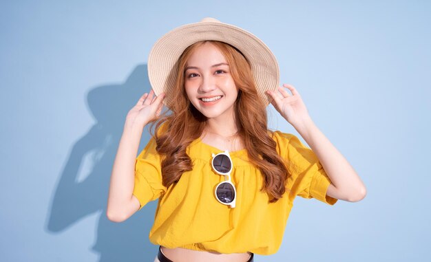 Portrait of young Asian girl on blue background summer vacation concept