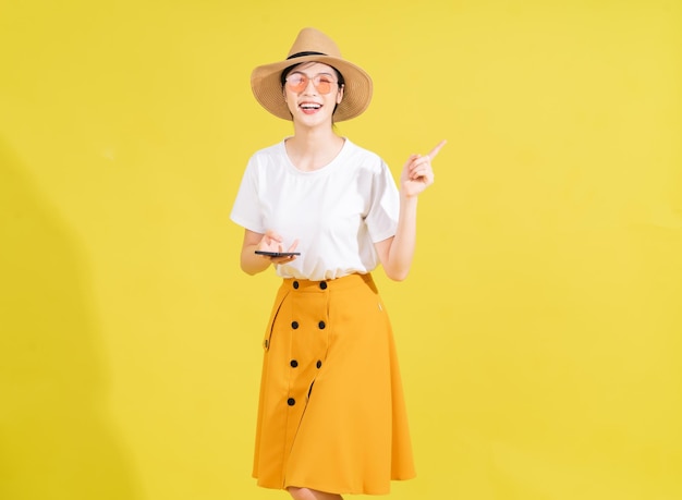 Portrait of young Asian girl on yellow background