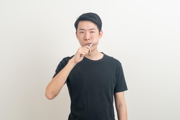 portrait young Asian man brush teeth on white background