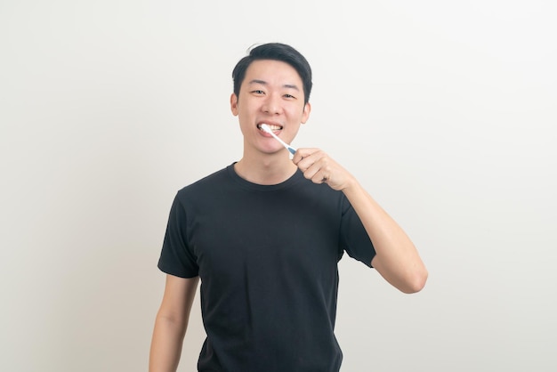 portrait young Asian man brush teeth on white background