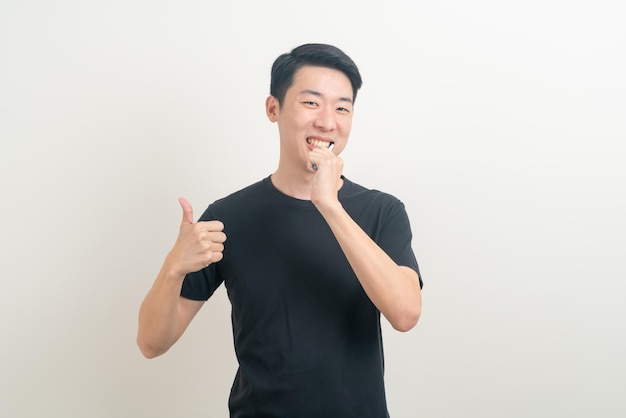 portrait young Asian man brush teeth on white background