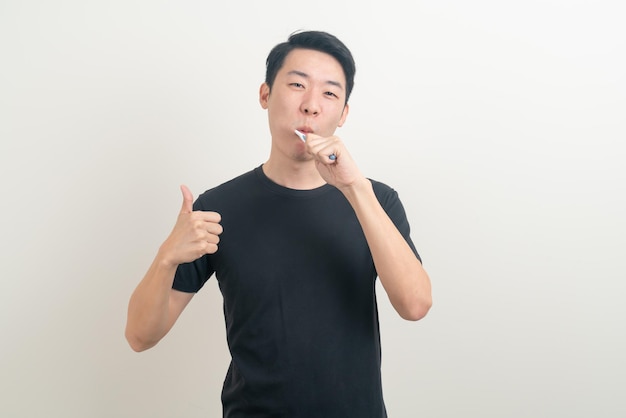 Portrait young Asian man brush teeth on white background