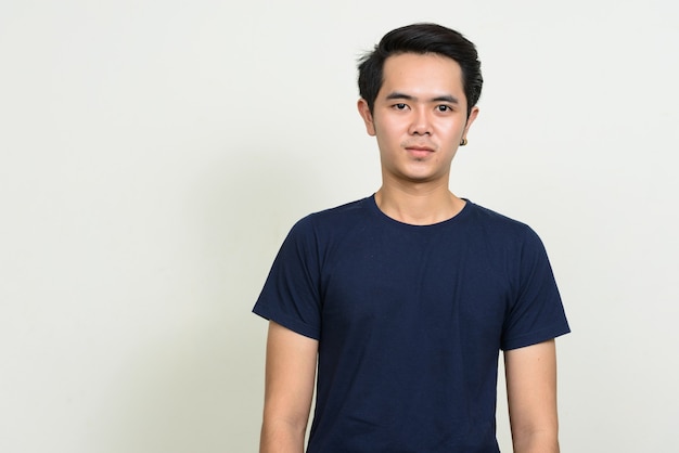 Portrait of young Asian man posing