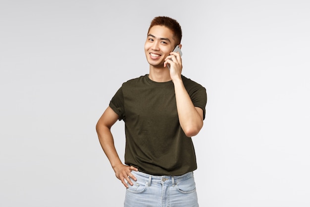 Portrait of a young asian man talking by phone