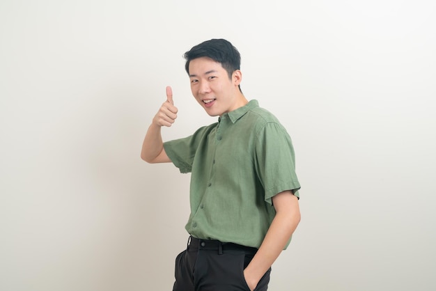 portrait young Asian man thumbs up or ok hand sign on white background