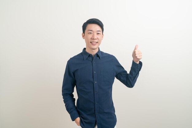 portrait young Asian man thumbs up or ok hand sign on white background