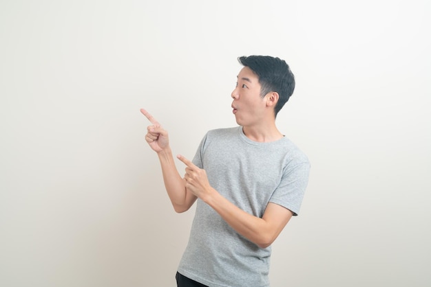 portrait young Asian man with hand pointing or presenting on white background