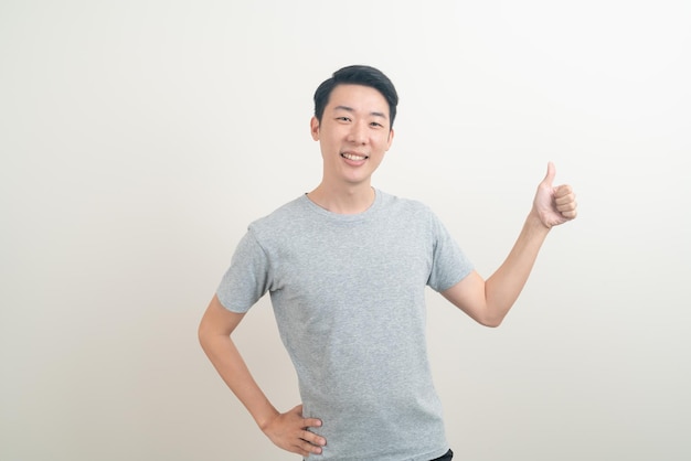 portrait young Asian man with hand pointing or presenting on white background