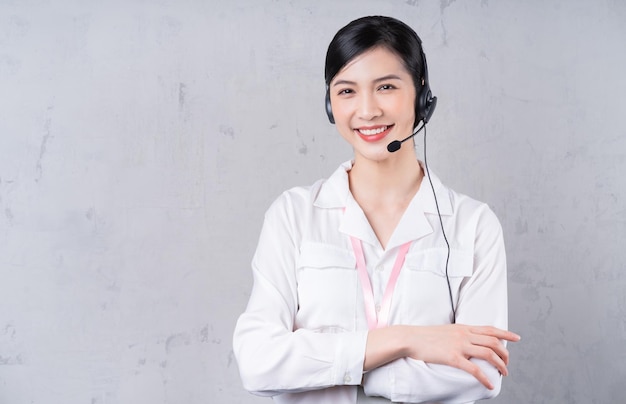 Portrait of young Asian operator on background