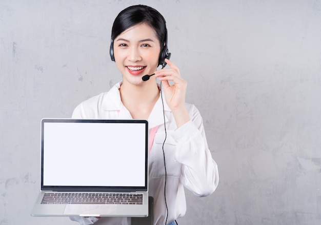 Portrait of young Asian operator on background